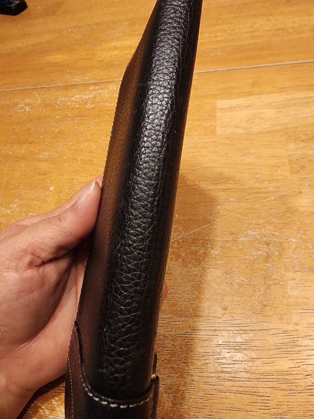 black Christian Dior pebbled leather trifold long wallet featuring gold-tone 